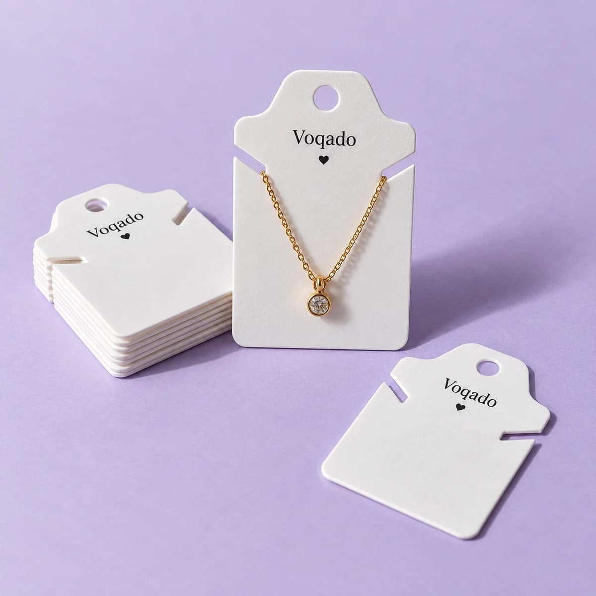 Plastic jewelry tags: original Voqado product visualization; styling and props are illustrative